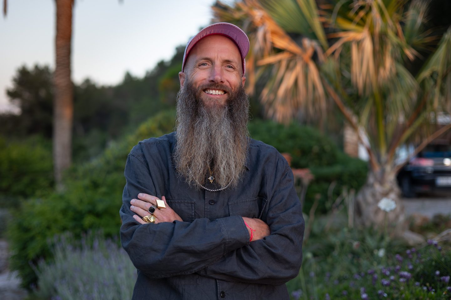 Peter Adams smiling in an Ibiza garden at golden hour